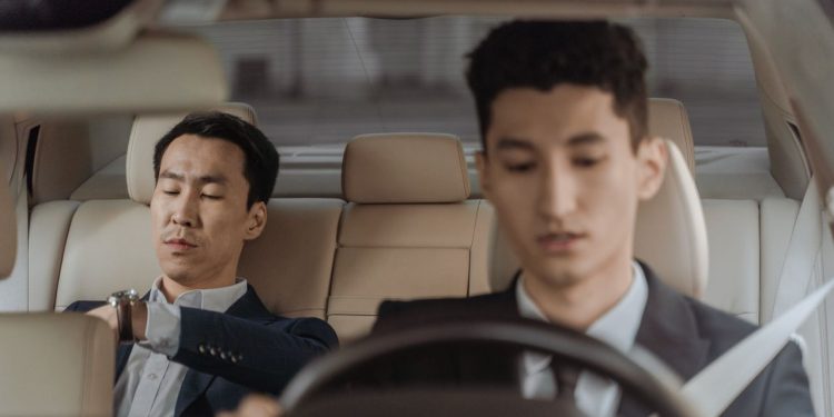 Professional chauffeur assisting passengers with a comfortable airport transfer in Cape Town